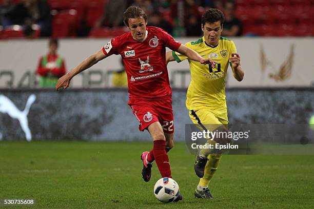 Vladimir Dyadyun of FC Rubin Kazan challenged by Shamil Gasanov of FC Anzhi Makhachkala during the Russian Premier League match between FC Rubin...