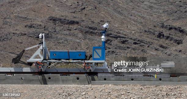 Recovery vehicle pushes a test sled is after it was propelled along a set of tracks during its first propulsion open air test at the Hyperloop One...