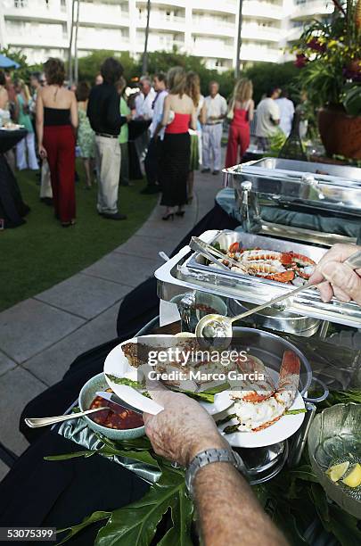 Foster Hull of Maui serves himself a plate of lobster at the Opening Night Twilight Reception of the Maui Film Festival at the Fairmont Kea Lani...