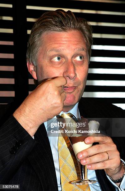 Belgium's Crown Prince Philippe tastes a chocolate cream at a Belgian Marcolini chocolate shop in Ginza on June 16, 2005 in Tokyo, Japan. The Prince...