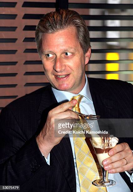 Belgium's Crown Prince Philippe tastes a chocolate cream at a Belgian Marcolini chocolate shop in Ginza June 16, 2005 in Tokyo, Japan. The Prince is...