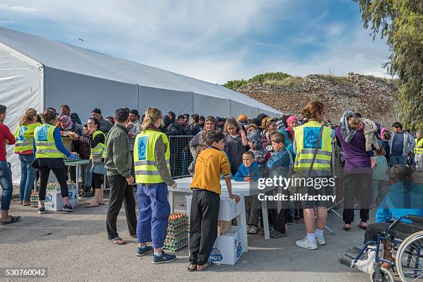 breakfast line in souda refugee camp on greek island chios - quiosque stock pictures, royalty-free photos & images