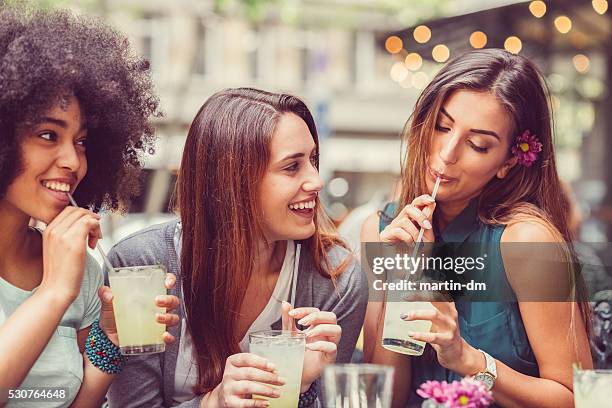 friends drinking cocktails together - outdoor cafe blur stock pictures, royalty-free photos & images