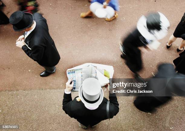 Racegoer studies the form in the crowd on the third day of Royal Ascot 2005, Ladie's Day, at York Racecourse on June 16, 2005 in York, England. One...