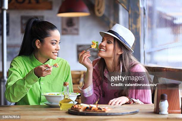 two female friends having lunch in restaurant - vinegar stock pictures, royalty-free photos & images