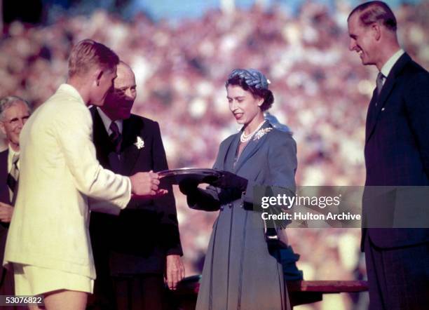 Queen Elizabeth II presents the Silver Salver to Australian tennis champion Lewis Hoad at Centre Court, Kooyong, during her trip to Australia, 1954....