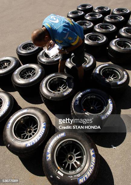 Renault F1 crew member Steve Larney checks Michelin tires in the pits on a preparation day for the Formula One United States Grand Prix, 16 June at...