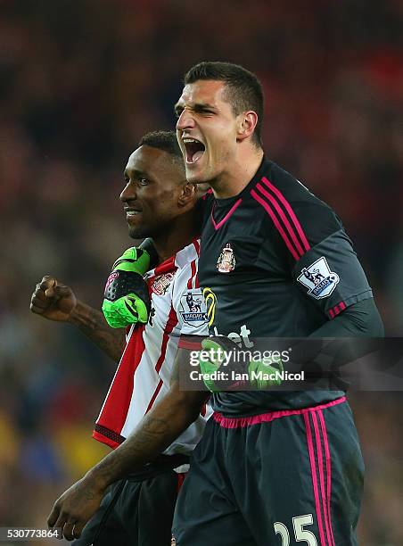 Jermain Defoe and Vito Mannone of Sunderland celebrate staying in the Premier League after the Barclays Premier League match between Sunderland and...