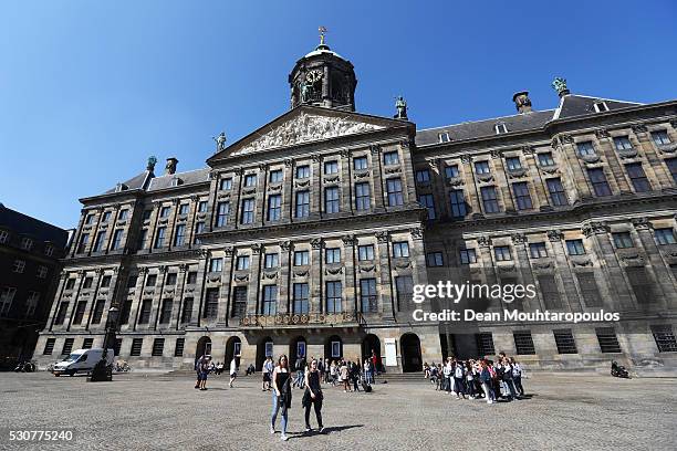 Tourists walk near the Royal Palace on May 11, 2016 in Amsterdam, Netherlands. The Royal Palace or Koninklijk Paleis Amsterdam or Paleis op de Dam in...