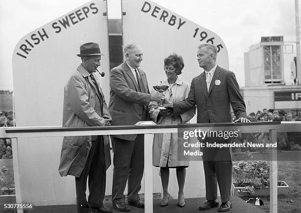 Mr Joseph McGrath presenting the Irish Sweeps Derby trophy to Mr G M Bell, one of the co-owners of Meadow Court after its success at the Curragh on...