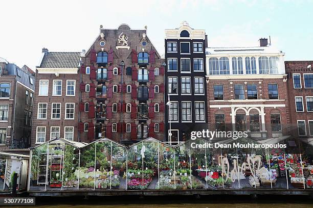 General view of the canal houses or grachtenpand in Dutch and flower market on Singel on May 11, 2016 in Amsterdam, Netherlands.