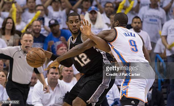 LaMarcus Aldridge of the San Antonio Spurs tries to break free from Serge Ibaka of the Oklahoma City Thunder during Game Four of the Western...