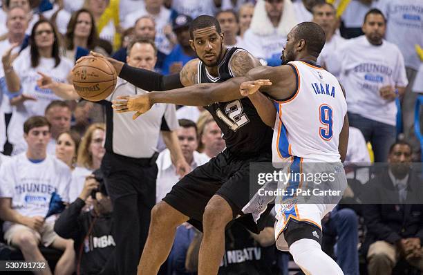 LaMarcus Aldridge of the San Antonio Spurs tries to break free from Serge Ibaka of the Oklahoma City Thunder during Game Four of the Western...