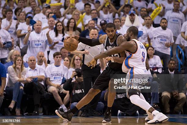 LaMarcus Aldridge of the San Antonio Spurs tries to break free from Serge Ibaka of the Oklahoma City Thunder during Game Four of the Western...