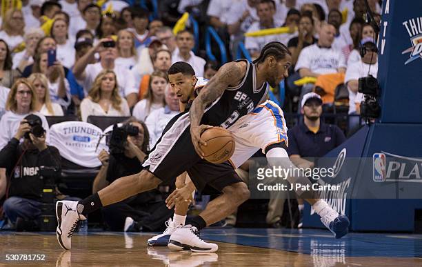 Kawhi Leonard of the San Antonio Spurs drives around Andre Roberson of the Oklahoma City Thunder during Game Four of the Western Conference...