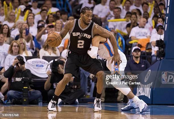 Kawhi Leonard of the San Antonio Spurs drives around Andre Roberson of the Oklahoma City Thunder during Game Four of the Western Conference...