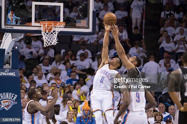 Russell Westbrook of the Oklahoma City Thunder and Tim Duncan of the San Antonio Spurs battle for the ball during Game Four of the Western Conference...