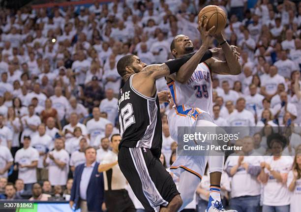 Kevin Durant of the Oklahoma City Thunder drives around LaMarcus Aldridge of the San Antonio Spurs as he looks for a two point shot during Game Four...