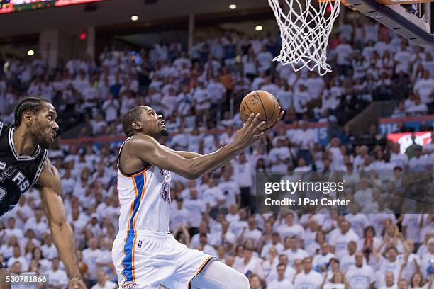 Kevin Durant of the Oklahoma City Thunder goes past Kawhi Leonard of the San Antonio Spurs for two points during Game Four of the Western Conference...