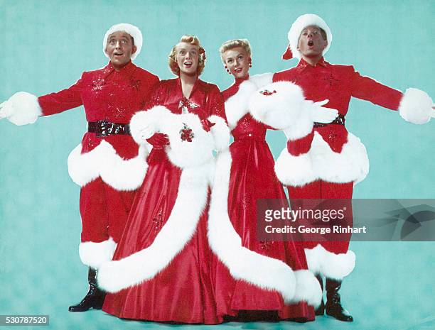 Left to right are; Actor Bing Crosby, Actresses Rosemary Clooney and Vera Ellen, and Actor Danny Kaye, dressed in Christmas colors as they sing...