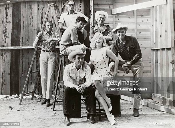 The cast, writer, and director of The Misfits. Clockwise from bottom are Montgomery Clift as Perce Howland, Eli Wallach as Guido, screenwriter Arthur...