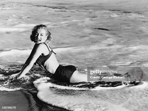 Marilyn Monroe lying in water.