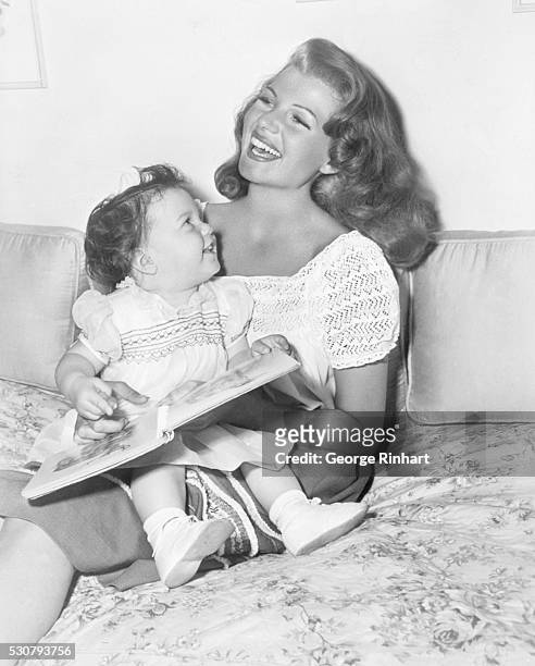 Rita Hayworth and her 16-month-old daughter Rebecca, whose father is Orson Welles.