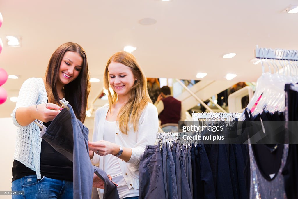 Friends shopping for clothes