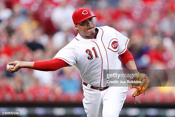 Alfredo Simon of the Cincinnati Reds throws to first base after fielding the ball in front of the mound against the Pittsburgh Pirates in the third...