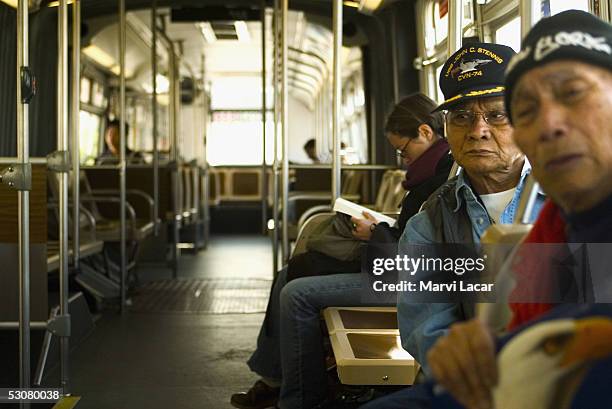 Friends Jose Recto and Epifanio Topaz sit on a bus headed to the Veterans Affairs Medical Center in Ft. Miley May 9, 2005 in San Francisco. The two...