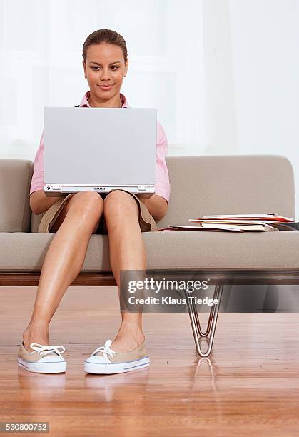 businesswoman with laptop - pigeon toed stockfoto's en -beelden