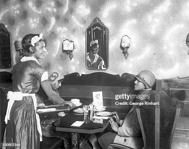 Two African American Women being served in a cafe by an African American waitress. Undated photograph circa 1920. BPA2# 4361