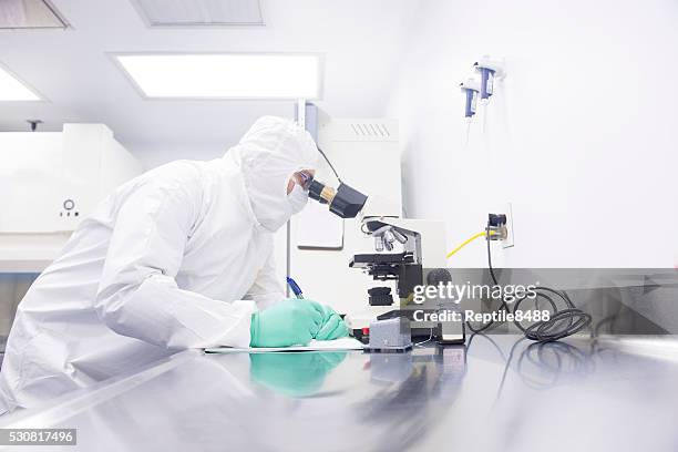 scientist in a clean room - white suit stock pictures, royalty-free photos & images