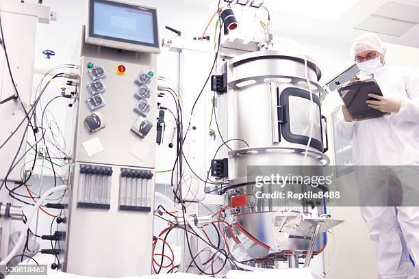 scientist with bioreactor - cleanroom stock pictures, royalty-free photos & images
