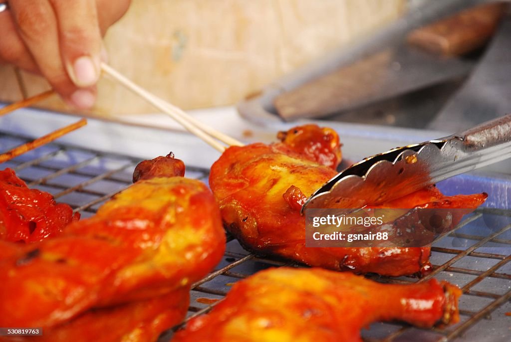 Grilling the chicken in skewers