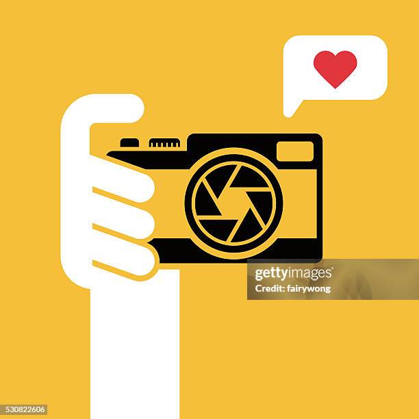 digital camera in human hand - pointing at camera stock illustrations