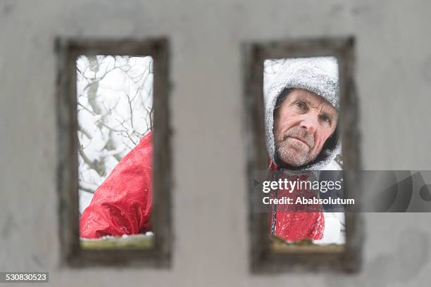 senior man at great war's bunker porthole , snowing, alps, europe - gulag stock pictures, royalty-free photos & images