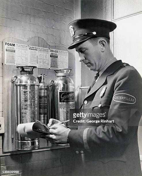 Officer Inspecting Fire Extinguishers