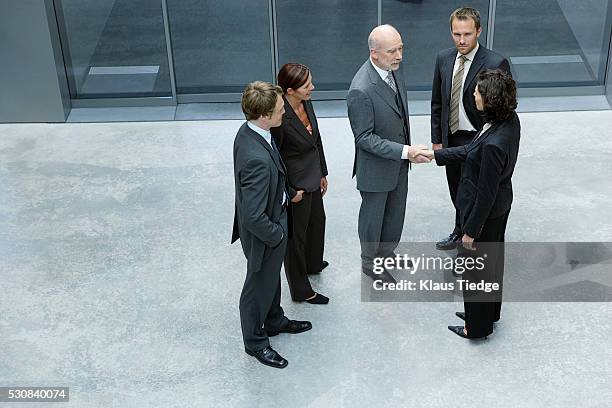 businesspeople greeting each other - sliding door exit stock pictures, royalty-free photos & images