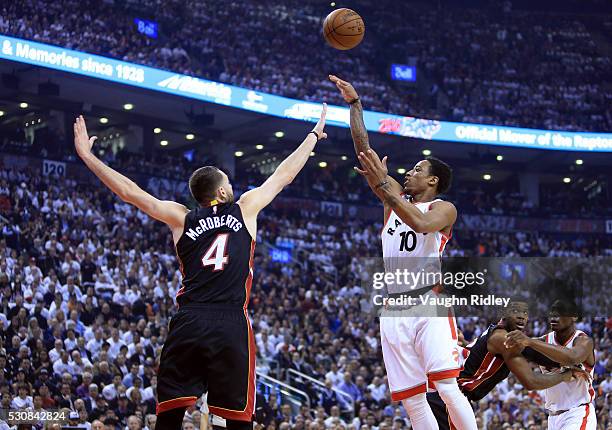 DeMar DeRozan of the Toronto Raptors shoots the ball as Josh McRoberts of the Miami Heat defends in the first half of Game Five of the Eastern...