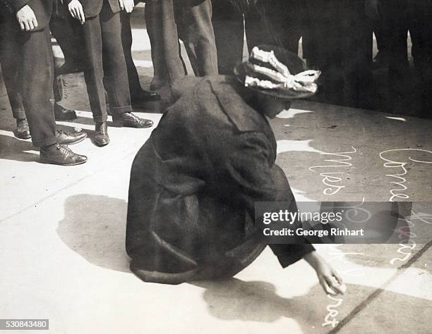 Suffragists Speak at Wall Street. Mrs. M. E. Baird writing in sidewalk advertising Pankhurst speech.