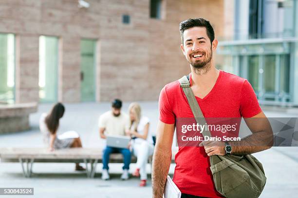 portrait of male student, group of students in the background - sling bag stock pictures, royalty-free photos & images