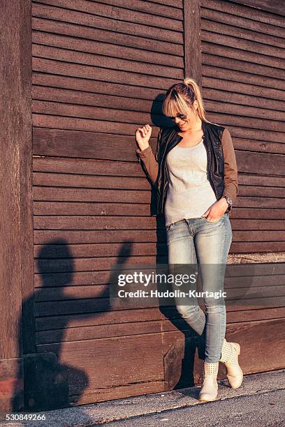 young woman looking at silhouette of young man on wooden wall - sillouette cool attitude stock pictures, royalty-free photos & images