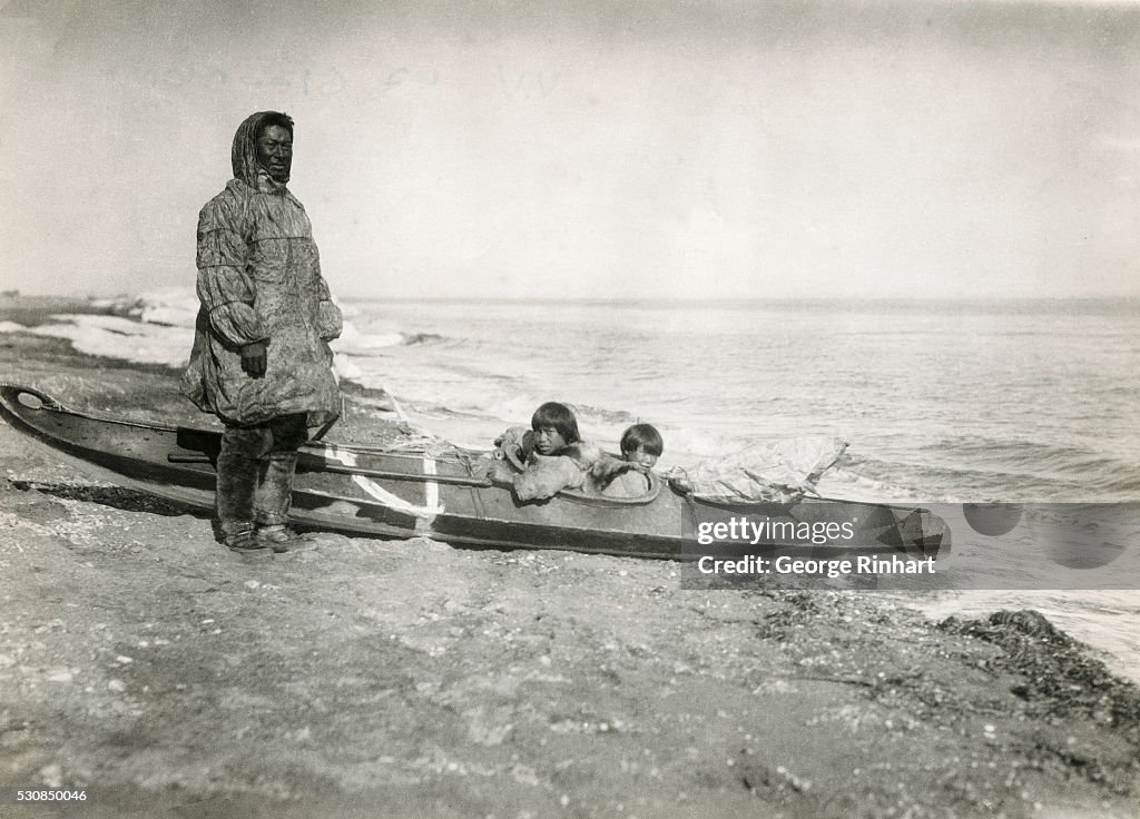 Inuit Man and Children Preparing to Shove Off in Canoe