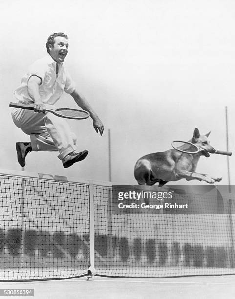 Jumping Jehosophat] James Murray and canine companion, a very mixed doubles, make tennis more strenuous. James Murray and his doubles partner, Flash,...