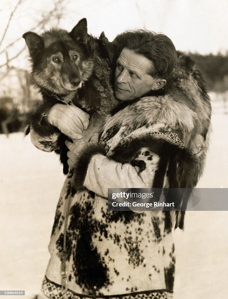 Dog Sled Racer Holding Lead Dog
