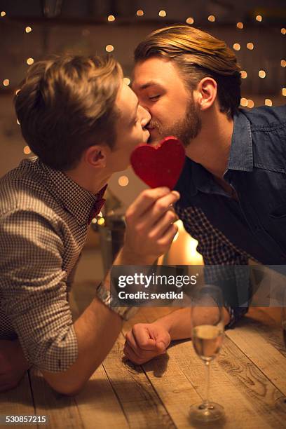 loving gay couple celebrating valentine's day. - champange bottle and valentines day stock pictures, royalty-free photos & images