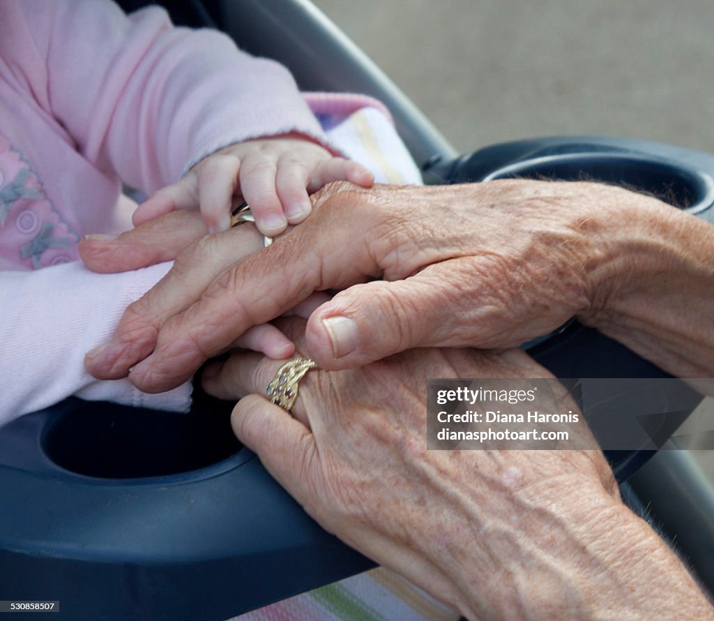 Baby and great grandmother's hands