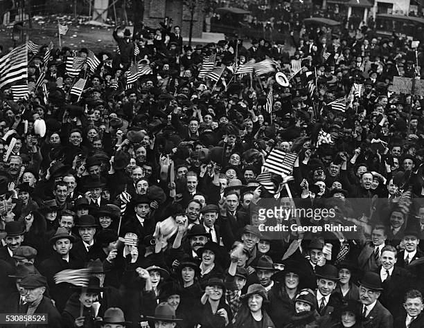Crowd cheering the end of World War I on Armistice Day, USA, November 11, 1918.