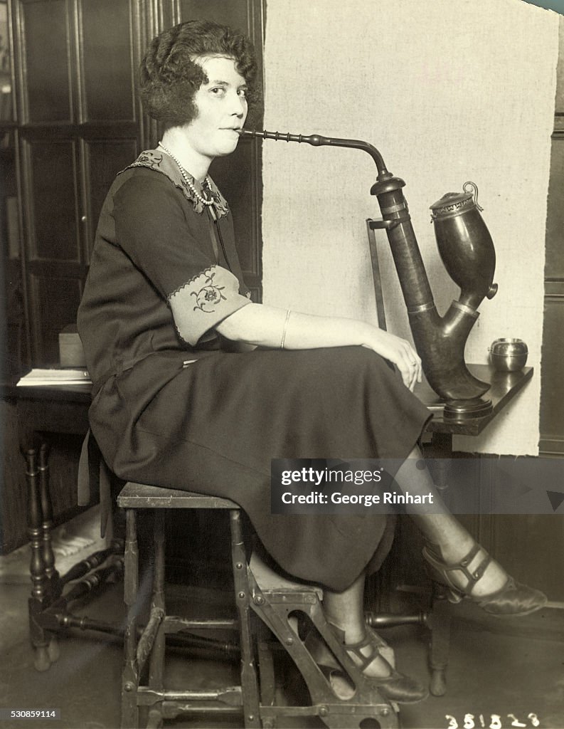 Woman Smoking from Pipe